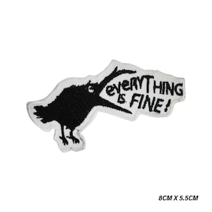 May include: Embroidered patch showing a black crow with the words "EVERYTHING IS FINE!" in black on a white background. The patch measures 8cm x 5.5cm, approximately 3.15 inches x 2.17 inches.