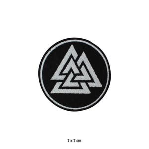 May include: A round black patch with a white triple triangle design, also known as the Valknut symbol. The patch is 7 x 7 cm.