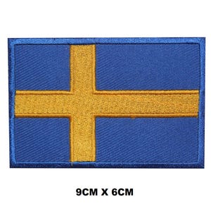 May include: An embroidered patch of the Swedish flag, featuring blue and yellow colours. The patch measures 9cm by 6cm.