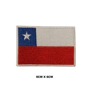 May include: Embroidered Chilean flag patch with a white star on a blue field, a white stripe, and a red stripe. The patch measures 9 cm by 6 cm.