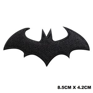 May include: Black embroidered iron-on patch of a bat silhouette, measuring 8.5 inches by 4.2 inches.