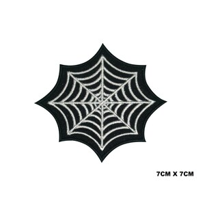 Peut inclure: Écusson noir et blanc en forme de toile d'araignée. Le patch a la forme d'une étoile avec un bord noir et un motif de toile d'araignée blanche. Il mesure 7 cm x 7 cm.