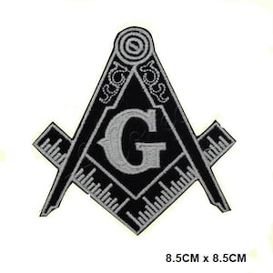 May include: Black and white embroidered patch featuring a compass and square with a letter G in the center. The patch is 8.5 inches by 8.5 inches.