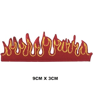 May include: A red embroidered flame patch with yellow detailing, measuring 9cm x 3cm. The flames are outlined in yellow thread, creating a vibrant contrast against the red background. Suitable for application on clothing or accessories. The patch is 3.5 inches x 1.2 inches.