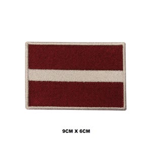 May include: Embroidered patch of the Latvian flag. The flag is red with a white horizontal stripe in the center. The patch is 9 inches by 6 inches.