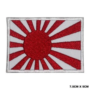 Op de afbeelding: Een witte geborduurde patch met een rood opkomend zonontwerp. De patch is 7,5 cm bij 5 cm.