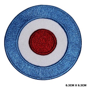 May include: A blue, white, and red embroidered patch with a target design. The patch is 6.3 inches in diameter.