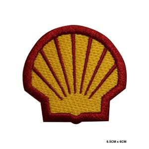May include: Red and yellow embroidered patch of a stylised seashell, 6.5 cm by 6 cm.