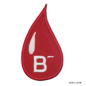 May include: Red blood drop shaped patch with white embroidered text "B- ", measuring 6 cm by 3.5 cm.
