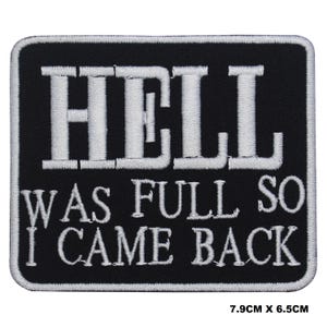 May include: Black embroidered patch with white text that reads "Hell was full so I came back". The patch measures 7.9 cm by 6.5 cm.