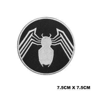 May include: Black and white embroidered patch featuring a stylised spider with eight legs and a circular design. The spider is white and the background is black. The patch is 7.5 cm by 7.5 cm.