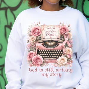 God Is Still Writing My Story typewriter sweatshirt | floral Christian design
