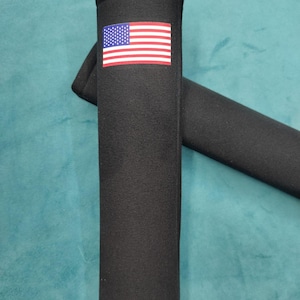 May include: Black fabric armrest covers with an American flag design. The covers are made of a soft, comfortable material and are designed to protect your armrests from wear and tear.