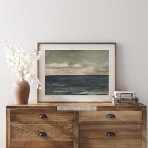 Vintage coastal art, muted ocean print, moody seascape painting for nursery. Antique seascape with navy blue hues and peaceful ocean view. Ideal for beach house decor or coastal nursery. Navy blue wall art with a serene maritime vibe, perfect for creating a calm and nautical atmosphere. Elegant, timeless artwork to complement any coastal or beach-themed interior.