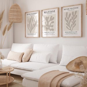 Set of 12 beige Henri Matisse inspired posters featuring abstract botanical shapes, geometric floral forms, and modern cut-out style designs. This neutral boho art collection uses soft beige tones and minimalist lines, making it ideal for a modern gallery wall, or mid-century modern home decor. Elegant abstract flowers and geometric modern art prints create a cohesive, calm aesthetic for living rooms, bedrooms, and stylish interiors.
