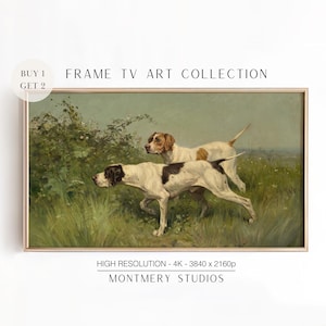 May include: A vintage painting of two white and brown hunting dogs in a grassy field. The dogs are running through the tall grass and appear to be on the hunt. The painting is framed in a gold frame.