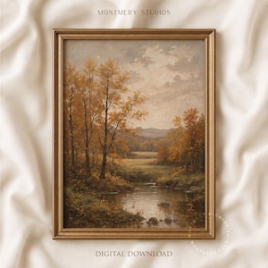 May include: A framed landscape painting in a gold-toned frame featuring a calm river flowing through a forest with autumn-coloured trees in shades of orange, yellow, and brown under a cloudy sky. The text MONTMERY STUDIOS and DIGITAL DOWNLOAD appear.