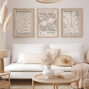 Set of 12 beige Henri Matisse inspired posters featuring abstract botanical shapes, geometric floral forms, and modern cut-out style designs. This neutral boho art collection uses soft beige tones and minimalist lines, making it ideal for a modern gallery wall, or mid-century modern home decor. Elegant abstract flowers and geometric modern art prints create a cohesive, calm aesthetic for living rooms, bedrooms, and stylish interiors.