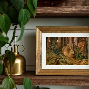 Vintage rabbit art print featuring a bunny in a forest scene, perfect for spring and Easter decor. Antique wildlife artwork with rustic nature charm, ideal for forest animal decor, nature-inspired wall art, and vintage bunny prints for home and cabin