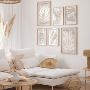 Set of 12 beige Henri Matisse inspired posters featuring abstract botanical shapes, geometric floral forms, and modern cut-out style designs. This neutral boho art collection uses soft beige tones and minimalist lines, making it ideal for a modern gallery wall, or mid-century modern home decor. Elegant abstract flowers and geometric modern art prints create a cohesive, calm aesthetic for living rooms, bedrooms, and stylish interiors.