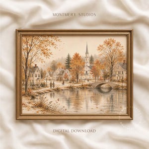 Puede incluir: Una impresión artística enmarcada titulada MONTMERY STUDIOS que muestra un paisaje de pueblo en otoño. La escena incluye casas, una iglesia con campanario, un puente de piedra sobre un río y árboles con follaje naranja. Texto: DIGITAL DOWNLOAD.