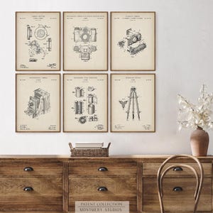 Set of 12 vintage photography patent prints featuring classic camera designs, Polaroid patent art, tripod, flash, lens, and film cartridge illustrations. Perfect wall art for photographers, photography studios, camera collectors, or office decor. Ideal gift for photography lovers, film enthusiasts, or vintage blueprint print collectors. Great for gallery walls, creative spaces, and retro home decor themes.