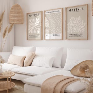 Set of 12 beige Henri Matisse inspired posters featuring abstract botanical shapes, geometric floral forms, and modern cut-out style designs. This neutral boho art collection uses soft beige tones and minimalist lines, making it ideal for a modern gallery wall, or mid-century modern home decor. Elegant abstract flowers and geometric modern art prints create a cohesive, calm aesthetic for living rooms, bedrooms, and stylish interiors.
