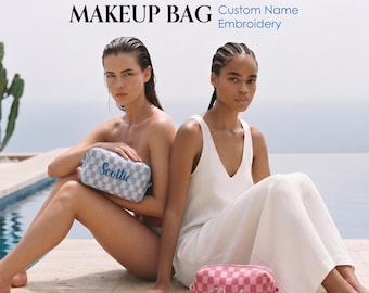 May include: Two rectangular makeup bags featuring a checkered pattern and custom name embroidery. One bag is light blue with the name Scottie, and the other is pink with the name Paisley. Text reads: PERSONALIZED MAKEUP BAG Custom Name Embroidery.
