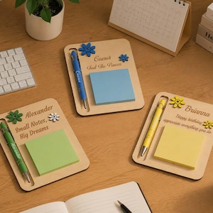 May include: Three rectangular light wood memo boards with integrated pen slots, each holding a colored sticky note pad and a matching pen. The boards feature personalized names, floral accents, and printed text including "Small Notes, Big Dreams."