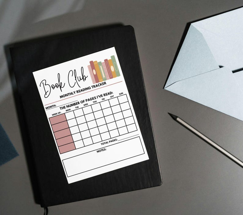 May include: A white Book Club monthly reading tracker with a colorful stack of books graphic. The tracker includes spaces to record the number of pages read each day of the week, with sections for the month, week of, total pages, and notes. It rests on a black notebook.