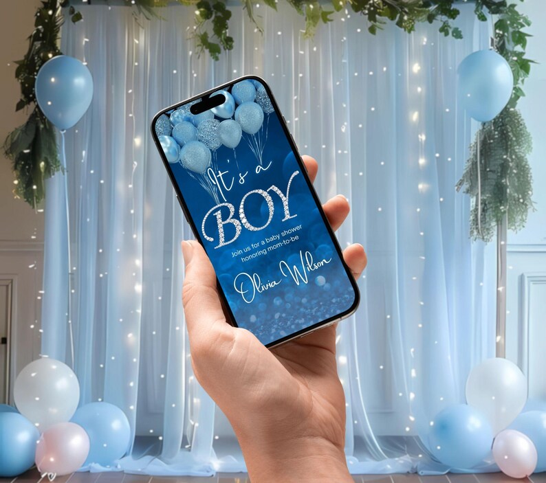 May include: A blue and silver baby shower invitation on a smartphone screen. The invitation reads "It's a Boy" with blue and silver balloons in the background. The text also includes "Join us for a baby shower honouring mom-to-be Olivia Wilson."
