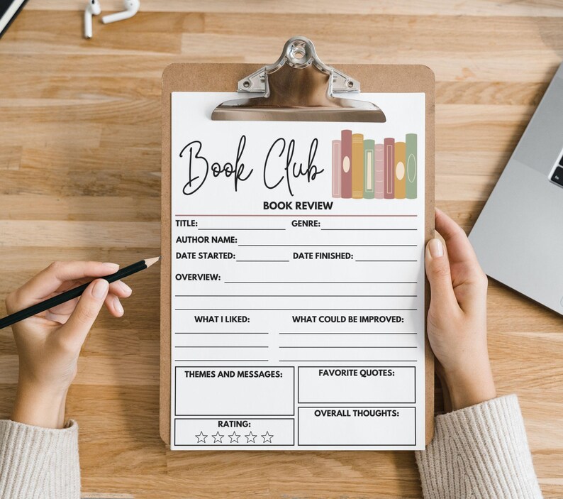May include: A clipboard with a "Book Club" book review form. The form includes sections for title, author, genre, and more. A hand holds a pencil, ready to write. The form has a decorative row of books.