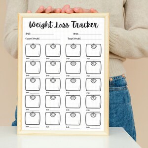 May include: A printable weight loss tracker with a wooden frame. The tracker has a grid of 20 weight scales with lines for recording dates, current weight, and target weight.