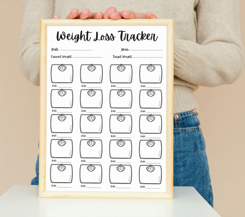 May include: A printable weight loss tracker with a wooden frame. The tracker has a grid of 20 weight scales with lines for recording dates, current weight, and target weight.