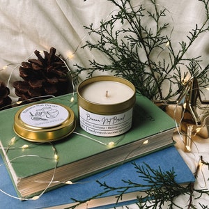 May include: A gold candle jar with a white label that reads "Banana Not Bread" and lists the ingredients: Walnut, Banana, Butter, Vanilla. The candle is hand-poured coconut apricot.