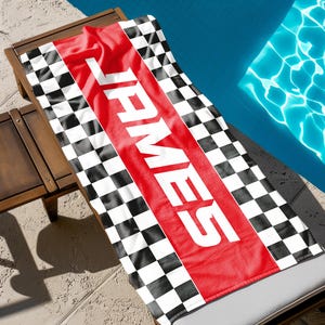 May include: A red and white checkered beach towel with the name "JAMES" printed in white on a red stripe.