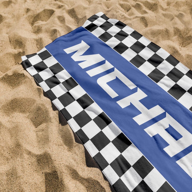 May include: A black and white checkered beach towel with a blue stripe and the name "MICHAEL" printed in white.