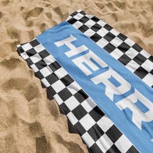 May include: A blue and white beach towel with a checkered pattern and the name "HEPRY" printed in white on a blue stripe.