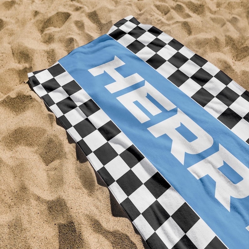 May include: A blue and white beach towel with a checkered pattern and the name "HEPRY" printed in white on a blue stripe.