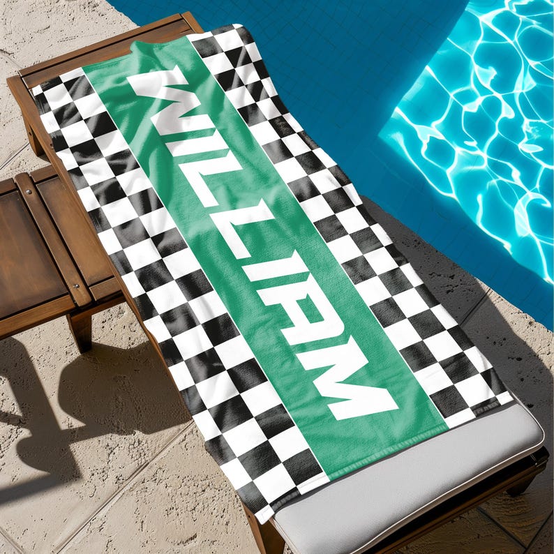 May include: A black and white checkered beach towel with a green stripe that says "WILL FARM" in white letters.