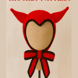 May include: A red crochet devil hat with black trim and horns, and a matching bow. The text "CROCHET PATTERN" is displayed at the top of the image. The hat is displayed on a mannequin head.