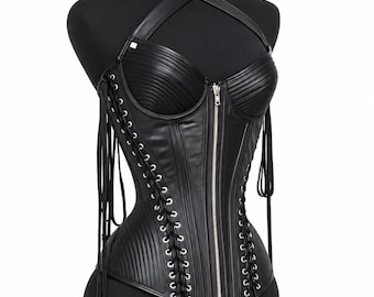 May include: A black corset featuring a front silver zipper, vertical ribbed panels, and side lacing with long hanging cords. The garment includes a halter-style neck strap and displays the Elite Worldwide Industry logo in the top corner.