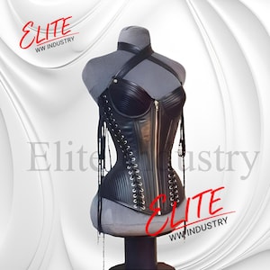 May include: A black leather corset with a halter neck and a front zipper. The corset is displayed on a gray mannequin. The corset has a lace-up back and decorative straps. The text "ELITE WW INDUSTRY" is visible in red.