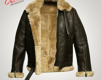 May include: A dark brown leather jacket with a thick tan shearling lining, a wide collar, and long sleeves with zippered cuffs. The jacket features a front zipper closure, a buckled waist strap, and the text Elite WW Industry in the top corner.