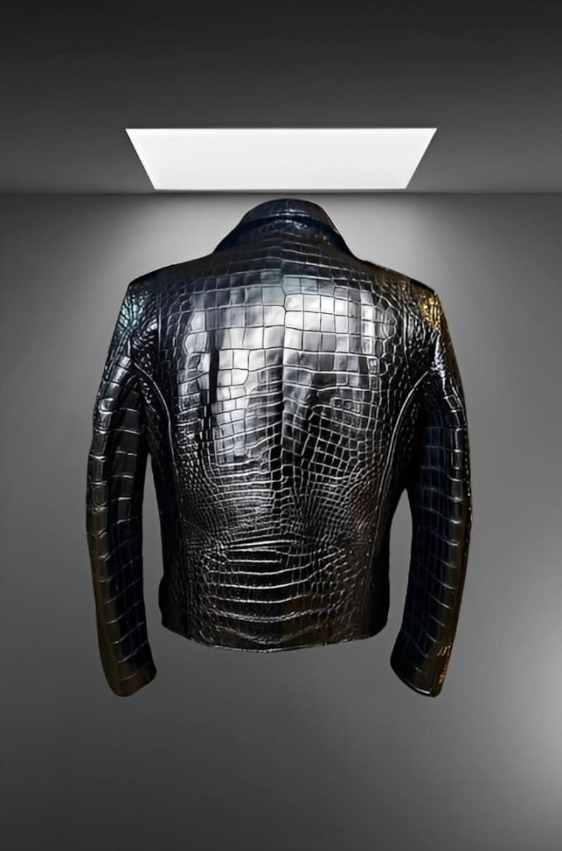 May include: A black leather jacket with a textured, crocodile-like pattern. The jacket has a classic design with a collar and long sleeves. The back of the jacket is visible, showcasing the intricate detailing of the material.