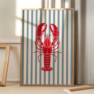 May include: A red lobster illustration on a blue and white striped background. The lobster is facing forward with its claws raised. The background is a simple pattern of vertical stripes.