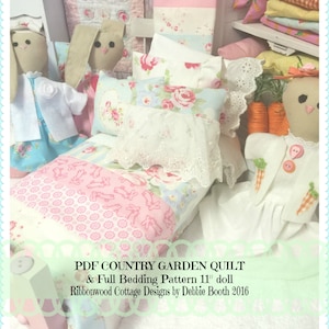 May include: A pink and white doll bed with a floral patterned quilt and pillows. The bed is decorated with a lace trim and a pink and white floral patterned fabric. The bed is accompanied by two bunny dolls and a doll dressed in a white dress. The text on the image reads "PDF COUNTRY GARDEN QUILT & Full Bedding Pattern 11" doll Ribbonwood Cottage Designs by Debbie Booth 2016".