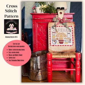May include: A cross-stitch pattern titled "Sourdough" displayed on a small red chair. The pattern features a bread loaf, bowls, and kitchen utensils. The image includes a red cabinet, a metal container, and text that reads "Cross Stitch Pattern" and "Deborah Booth 2025."