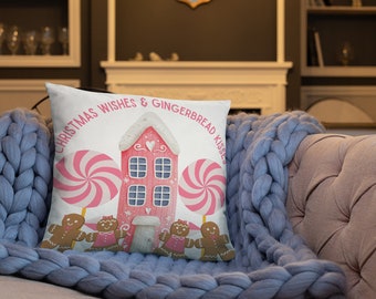 May include: A white throw pillow with a pink gingerbread house, candy canes, and gingerbread people. The pillow reads "Christmas Wishes & Gingerbread Kisses".
