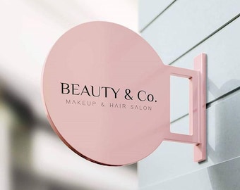 May include: A pink round sign with the text "BEAUTY & Co. MAKEUP & HAIR SALON" in black lettering.